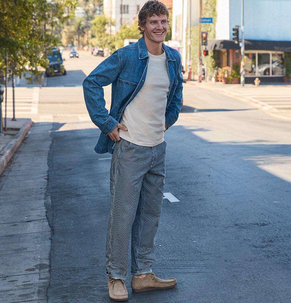 Man standing in a city street wearing the Lee Rail Road Carpenter jean.