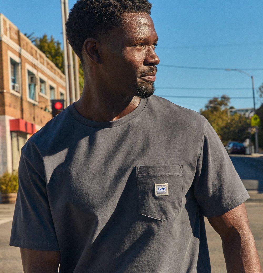 Man on street corner in the city wearing the Lee do-it-all-tee.