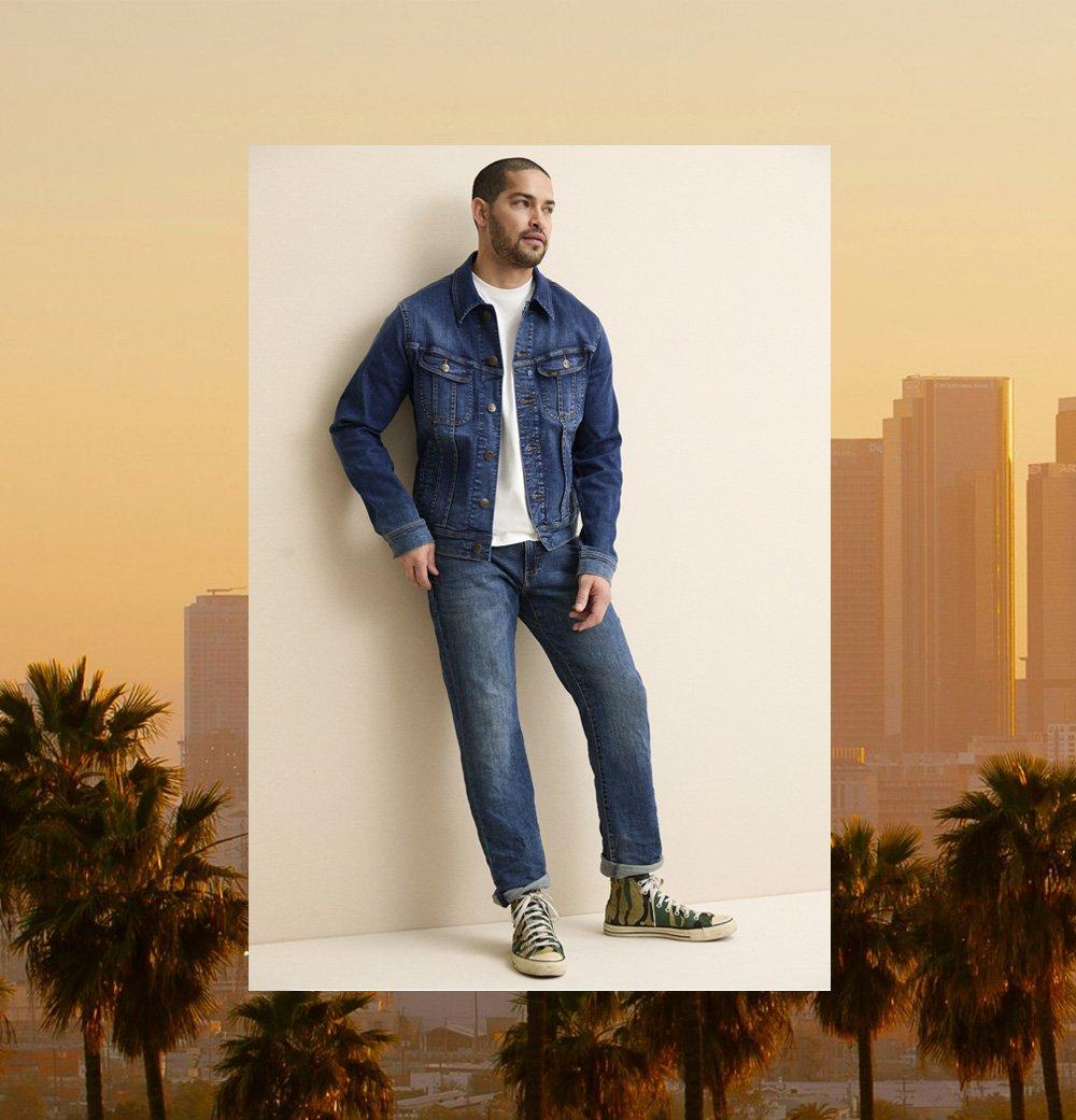 Man standing agains a wall wearing The Versatile Straight Taper Jean from Lee.