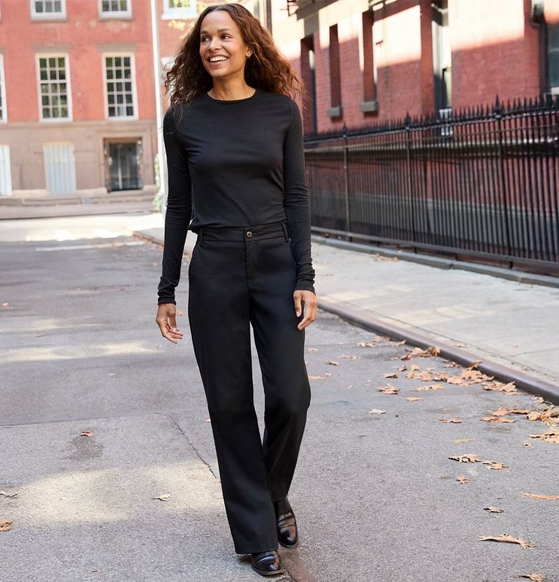 Woman walking down a city street wearing New fall pants from Lee.