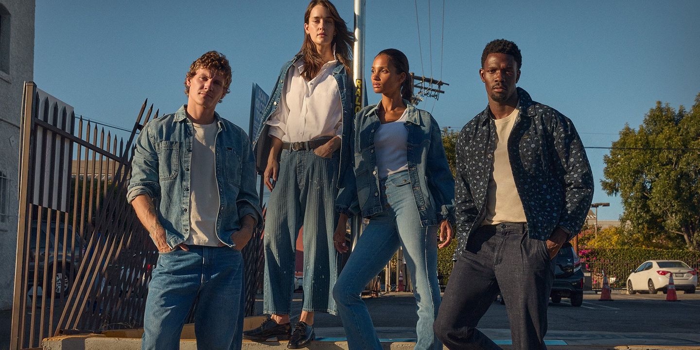 Group of friends standing on a stoop in the city wearing Lee denim. 
