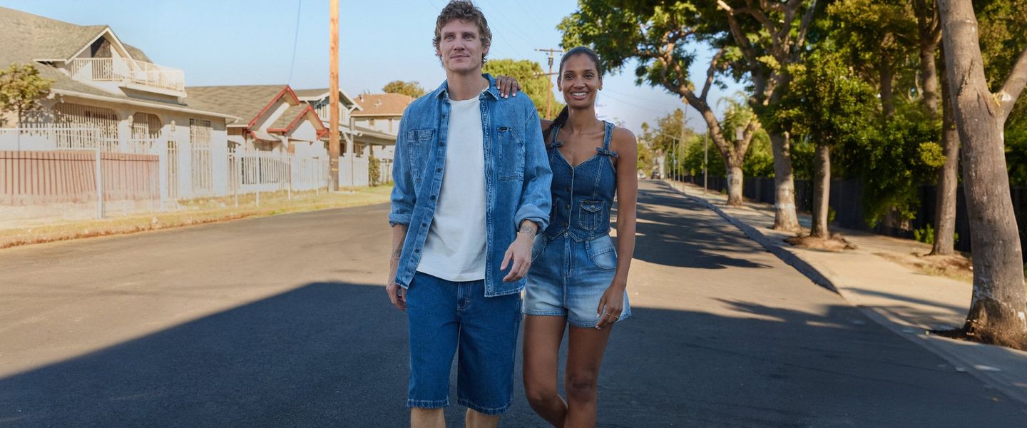 models (one man and one woman) featuring the OFF DUTY collection, wearing shorts while walking down the street